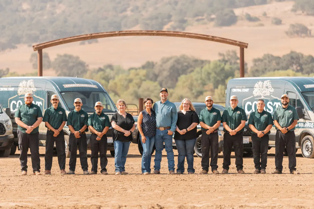 The Coast Plumbing Solutions team standing in front of the company service vans