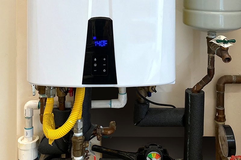 Tankless vs. Traditional Water Heaters: Which is Best for Your Home? Photo of a tankless water heater installed in a home.